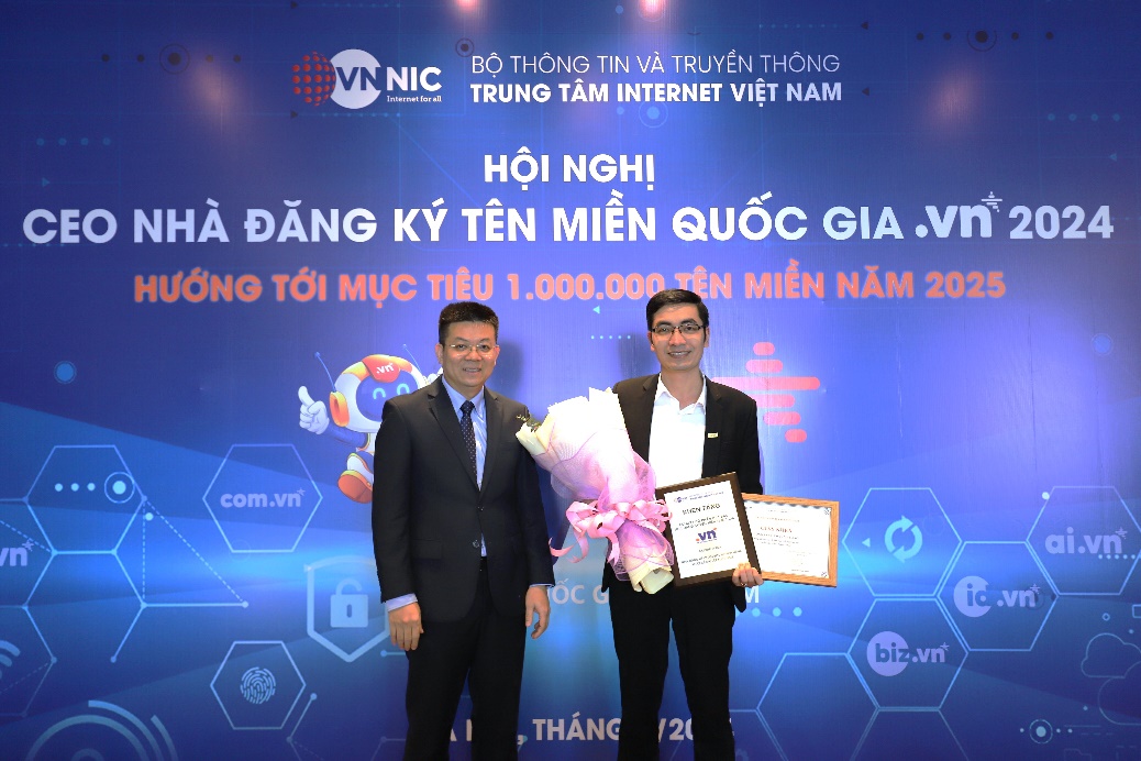 Two men standing in front of a blue backdrop

Description automatically generated